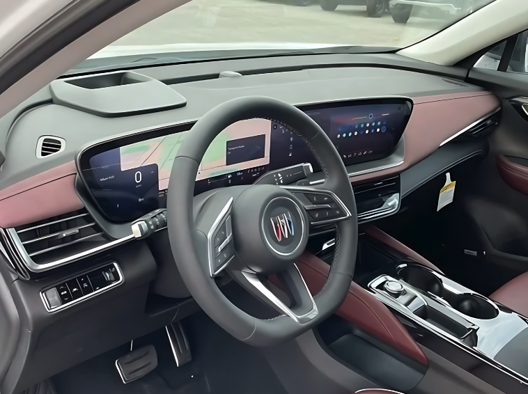 Interior view of the 2025 Buick Envision showing digital driver cluster, infotainment display, and two-tone upholstery